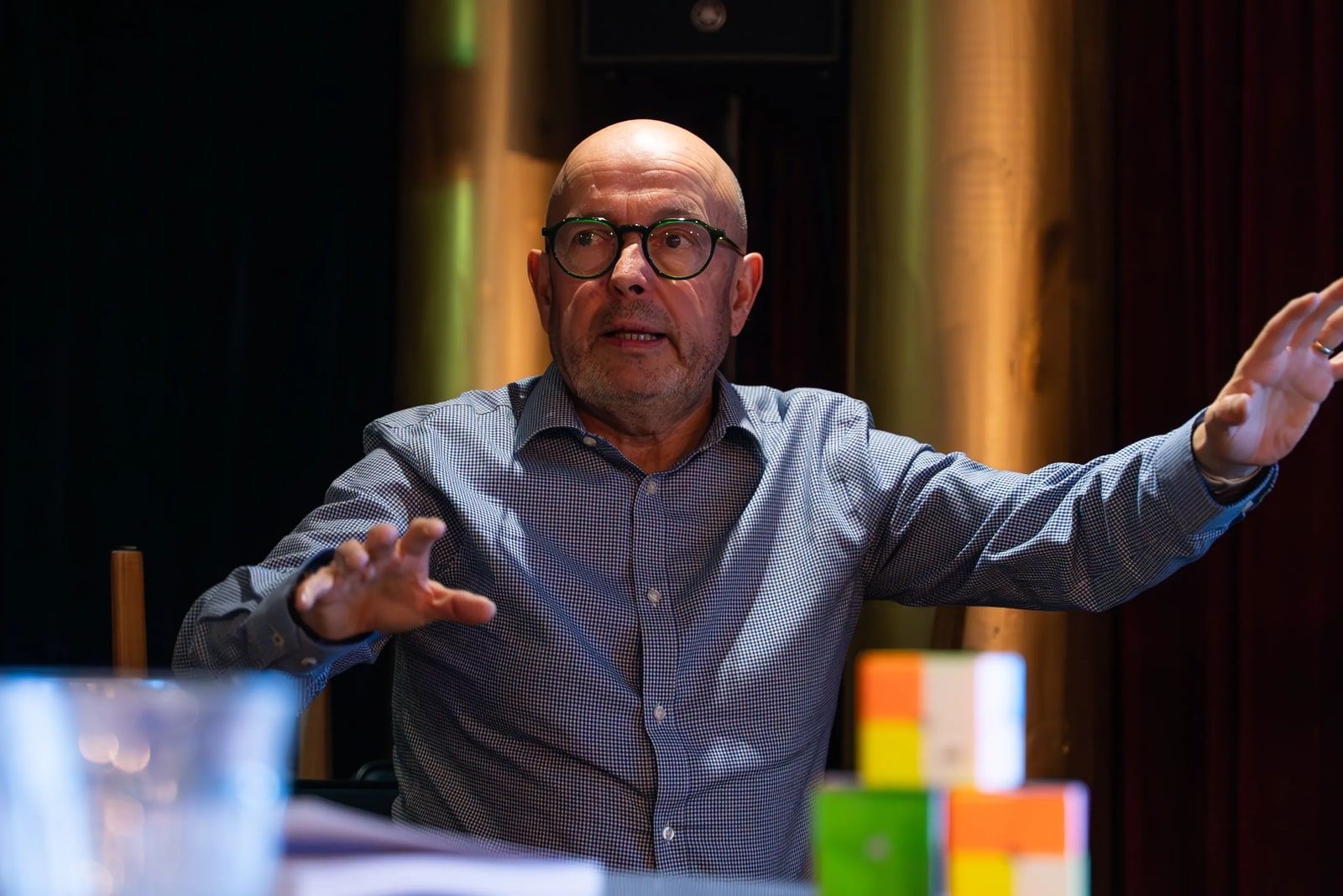 Ken Thompson mid-sentence, gesturing with both hands while facilitating a session